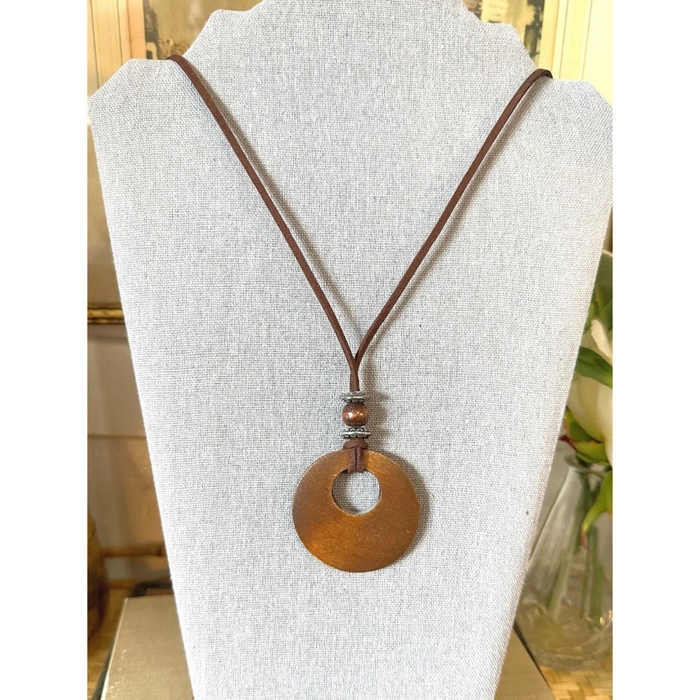 Brown wooden pendant necklace on a brown cord